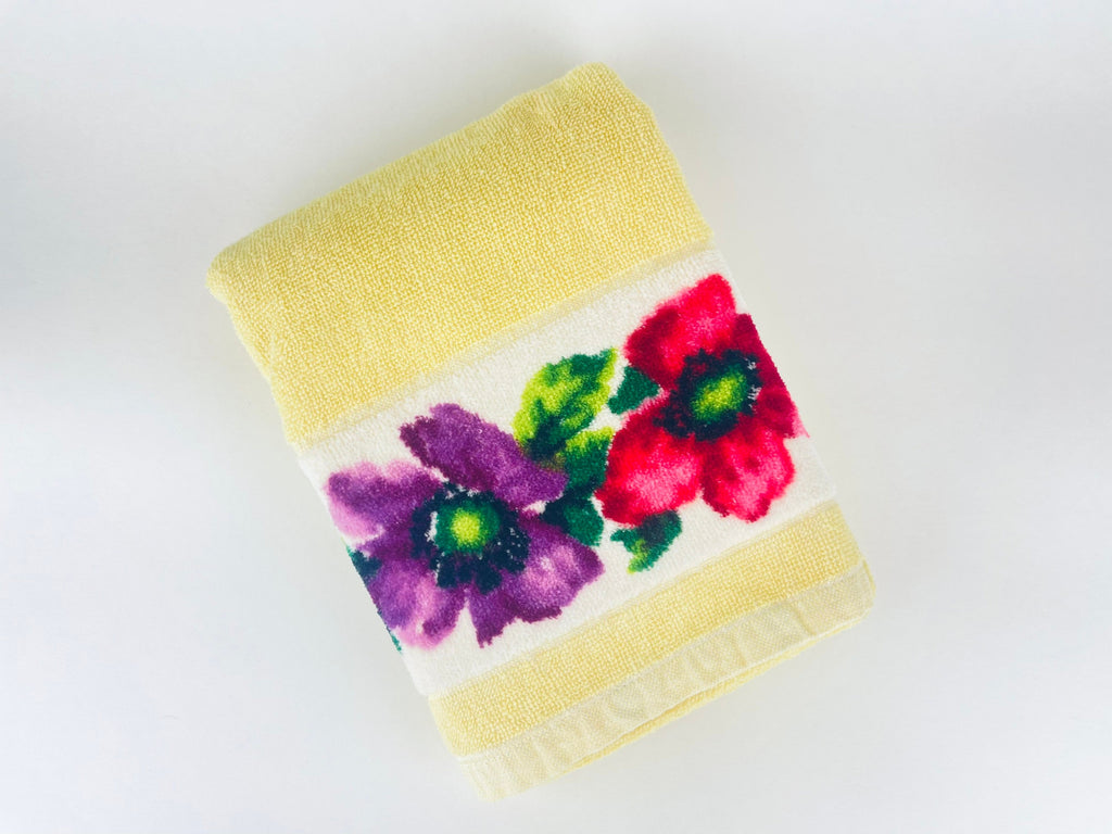 Bath towel with floral design on a white background