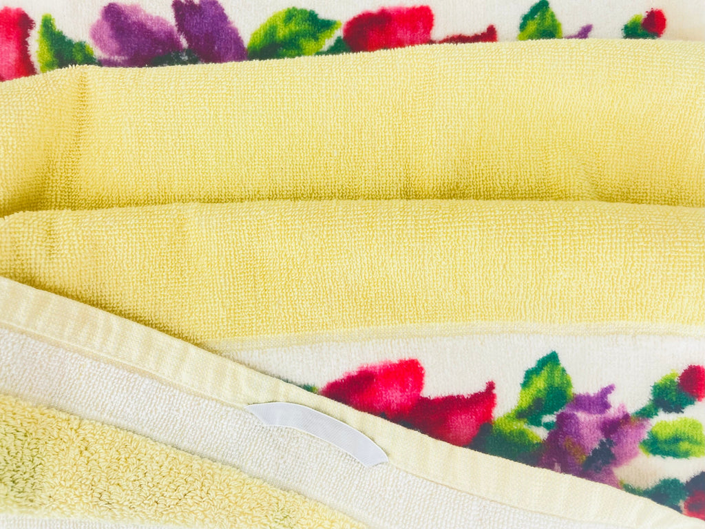 Yellow towel with floral patterned border