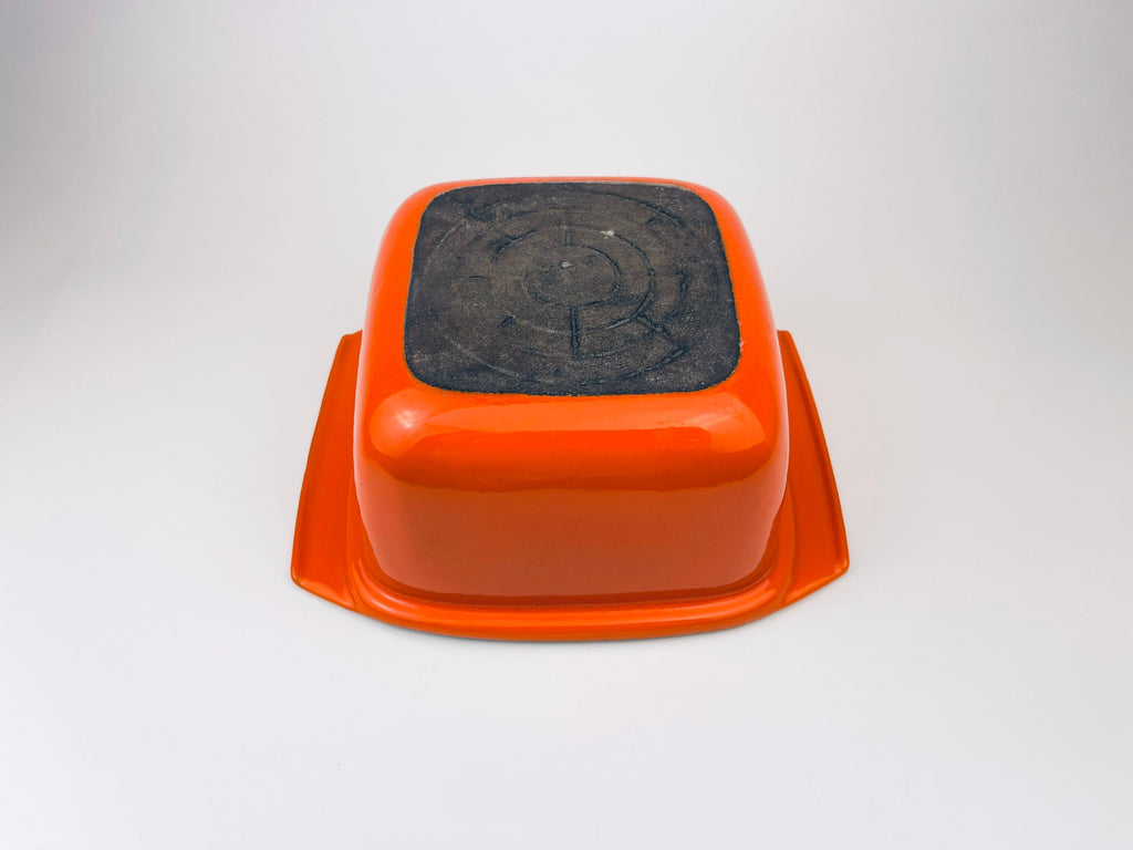 White ceramic coated cast iron square bowl on a light gray background