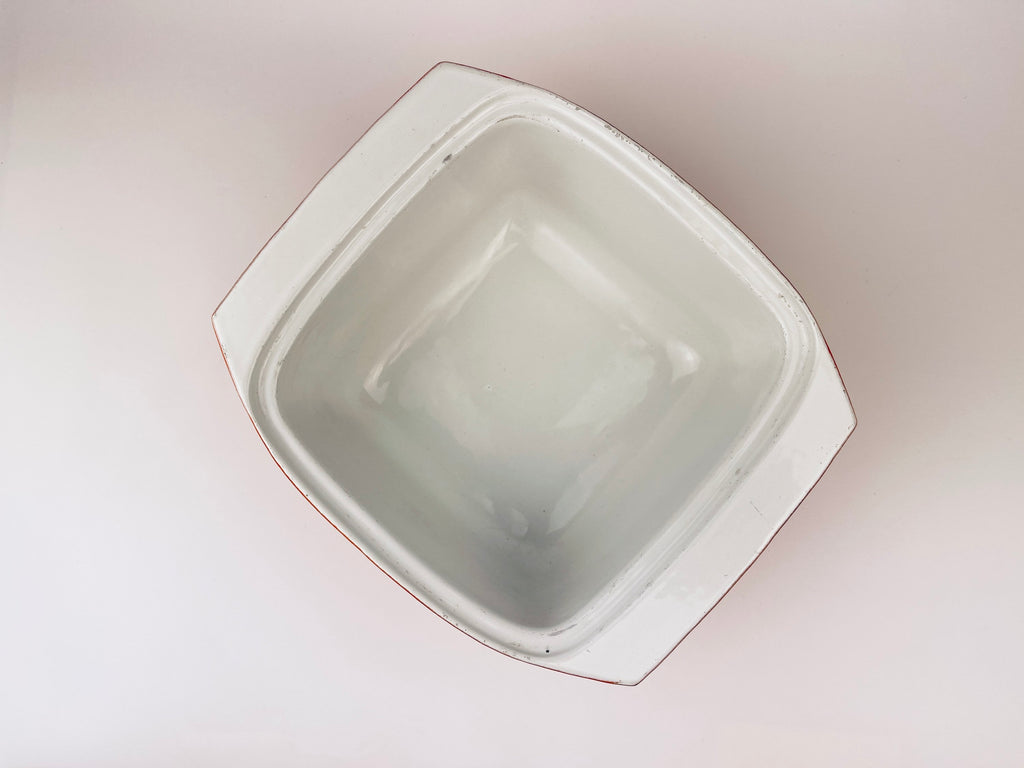 White ceramic coated cast iron square bowl on a light beige background