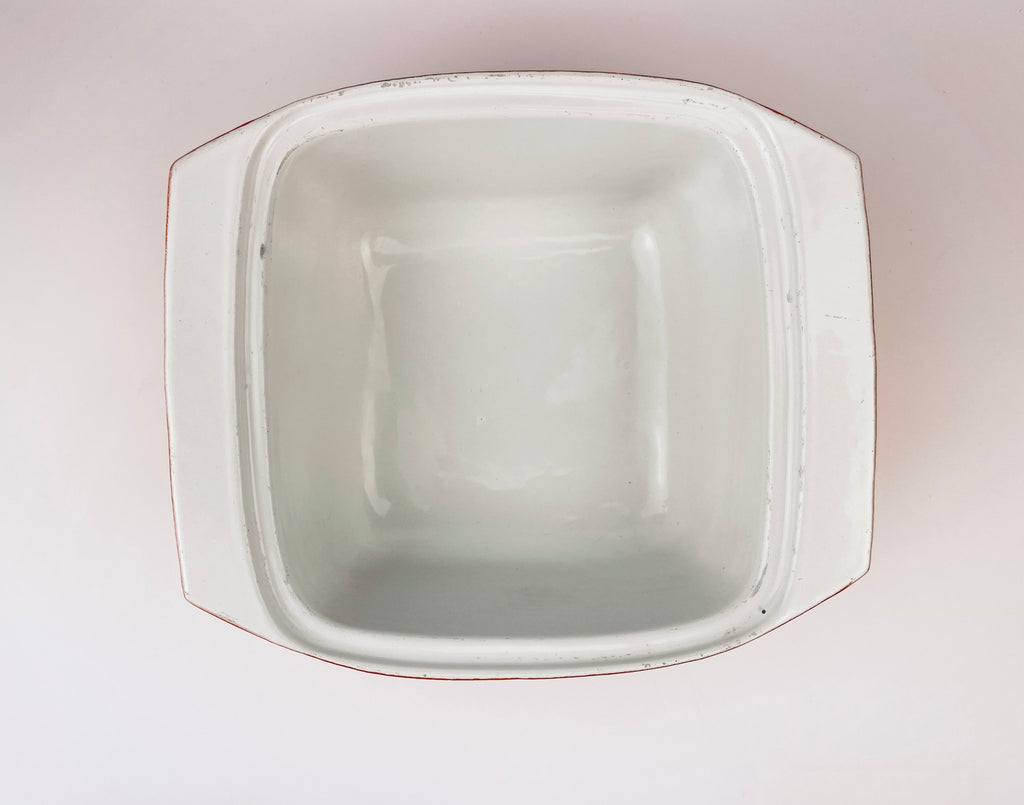 White ceramic coated cast iron square bowl on a light gray background