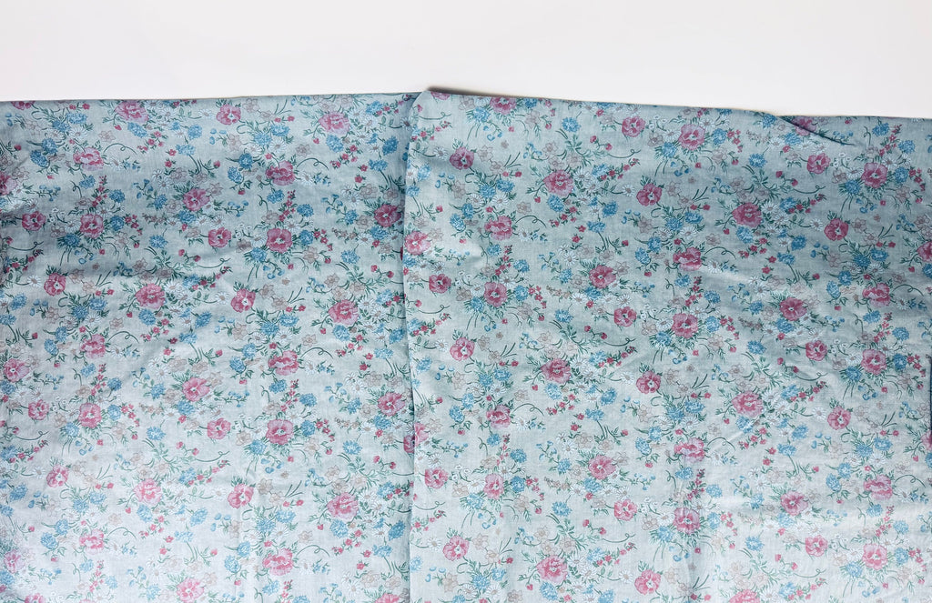 Floral fabric with pink and blue flowers on a white background