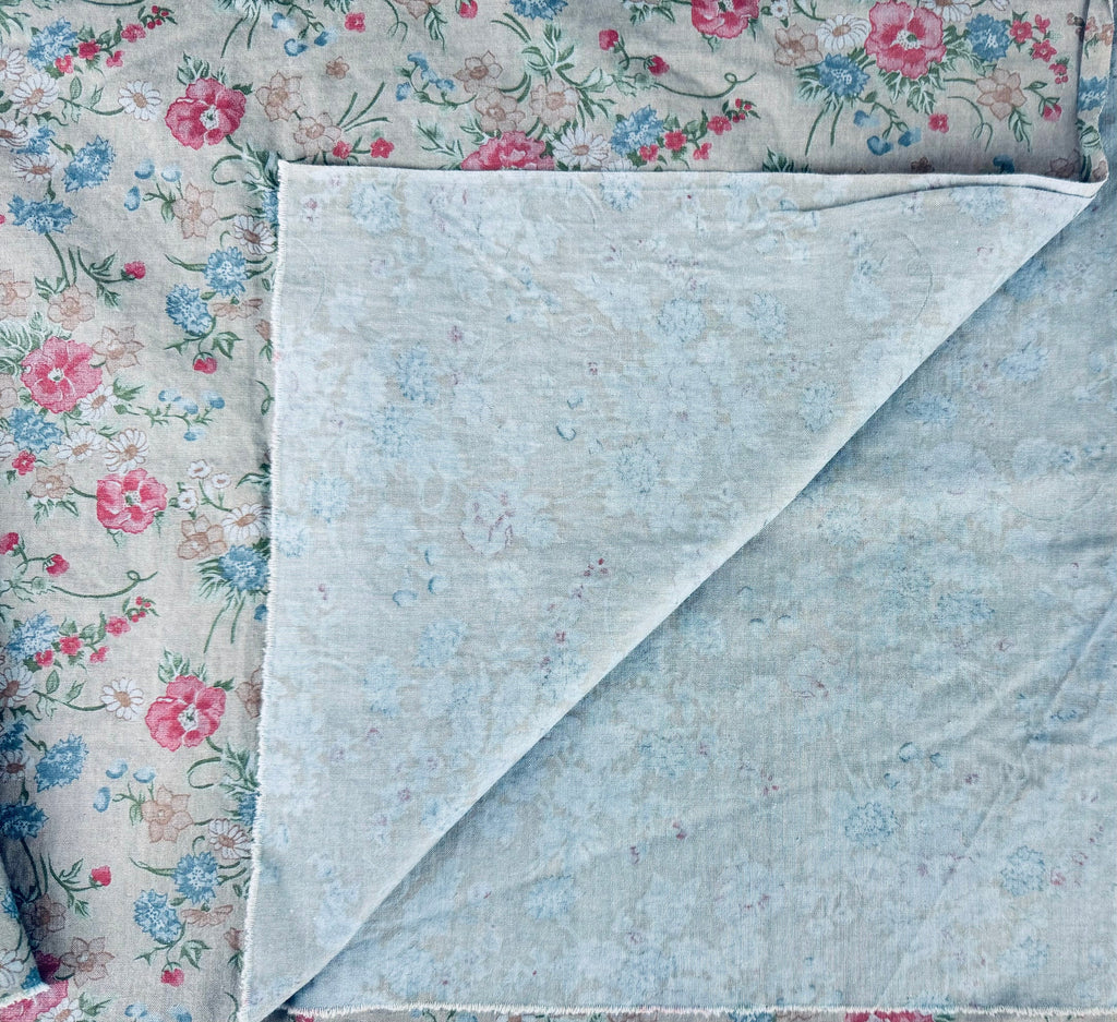 Floral fabric and a light blue textured fabric side by side