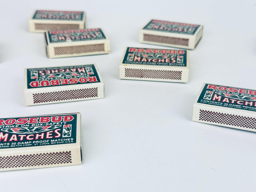 Multiple boxes of Rosebud matches on a light gray background