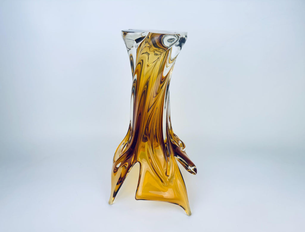 Glass vase with brown and clear design on a light gray background
