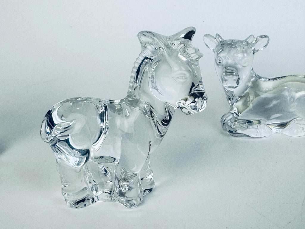 Crystal donkey and cow figurines from the Marquis by Waterford nativity set, positioned side by side.