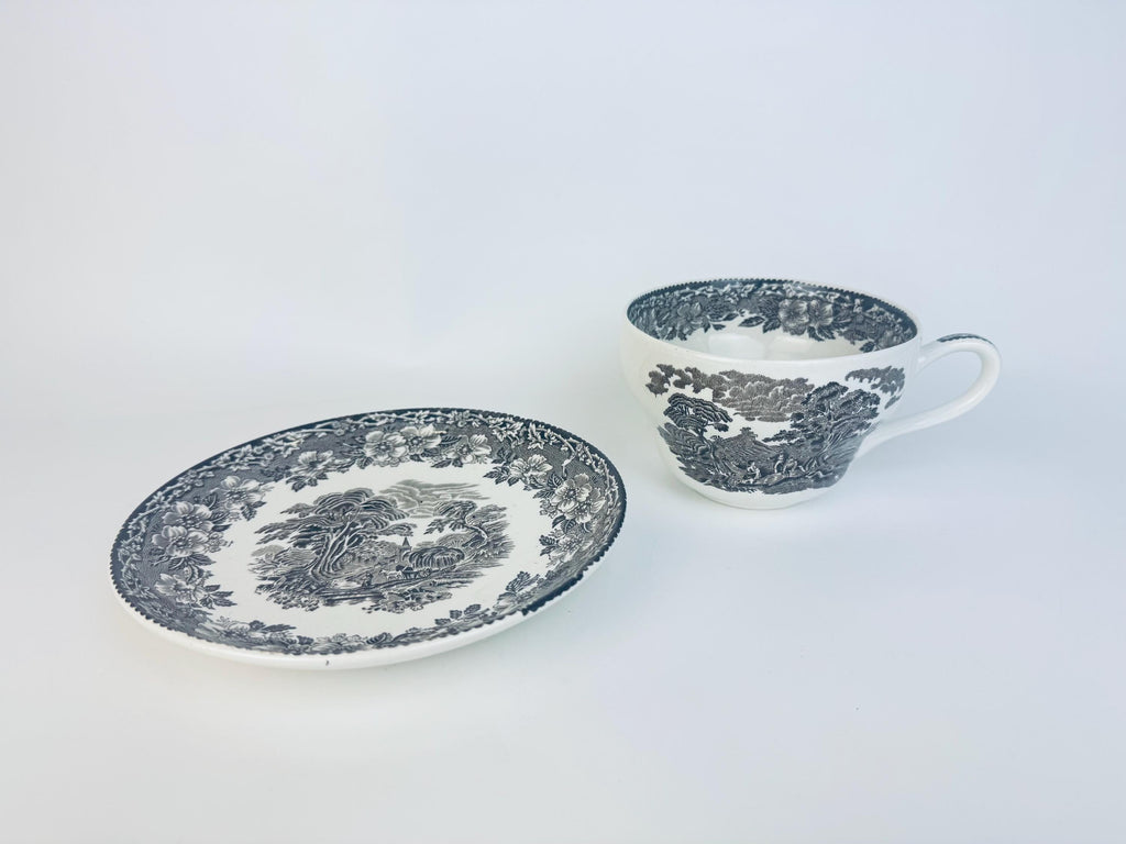 Teacup and saucer with floral pattern on a white background