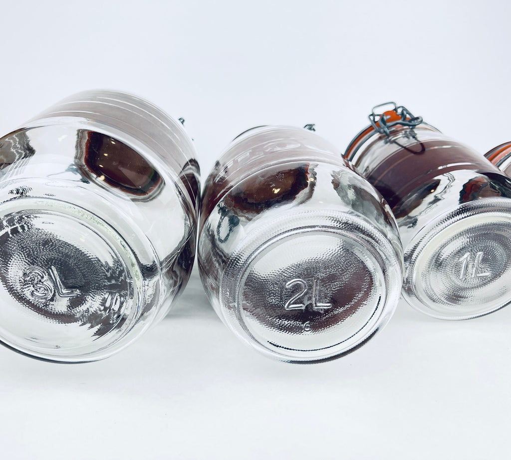 Product image for 'vintage brown striped glass canister set 1980s kitchen storage with orange seals' (view b594d6)