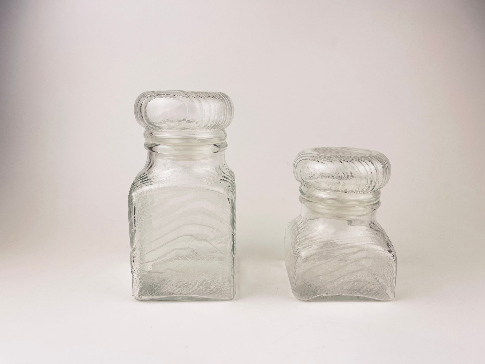 Product image for 'vintage 1970s airtight glass jars with faux wood grain lids set of 2' (view 30a631)