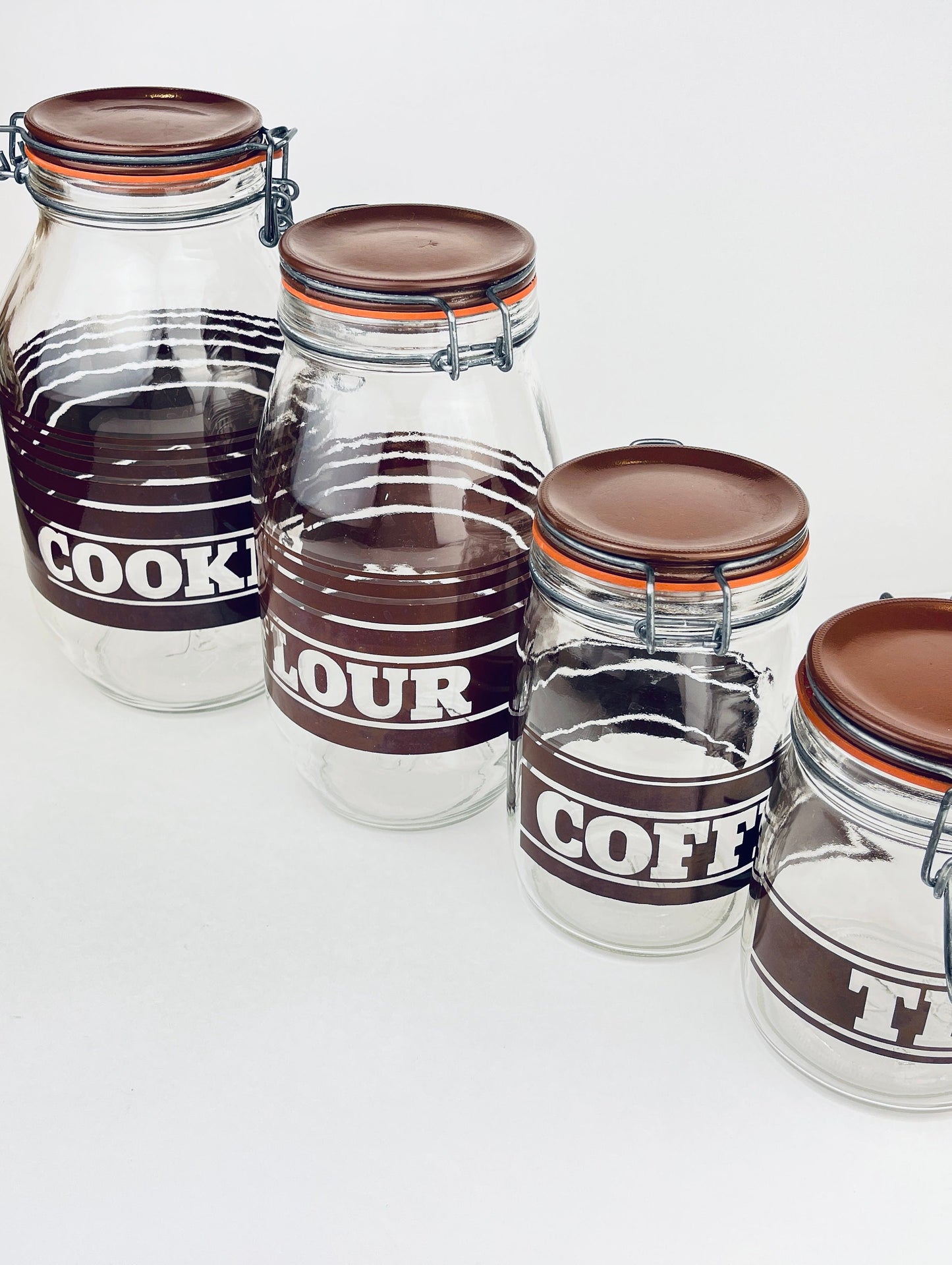 Product image for 'vintage brown striped glass canister set 1980s kitchen storage with orange seals' (view 234512)