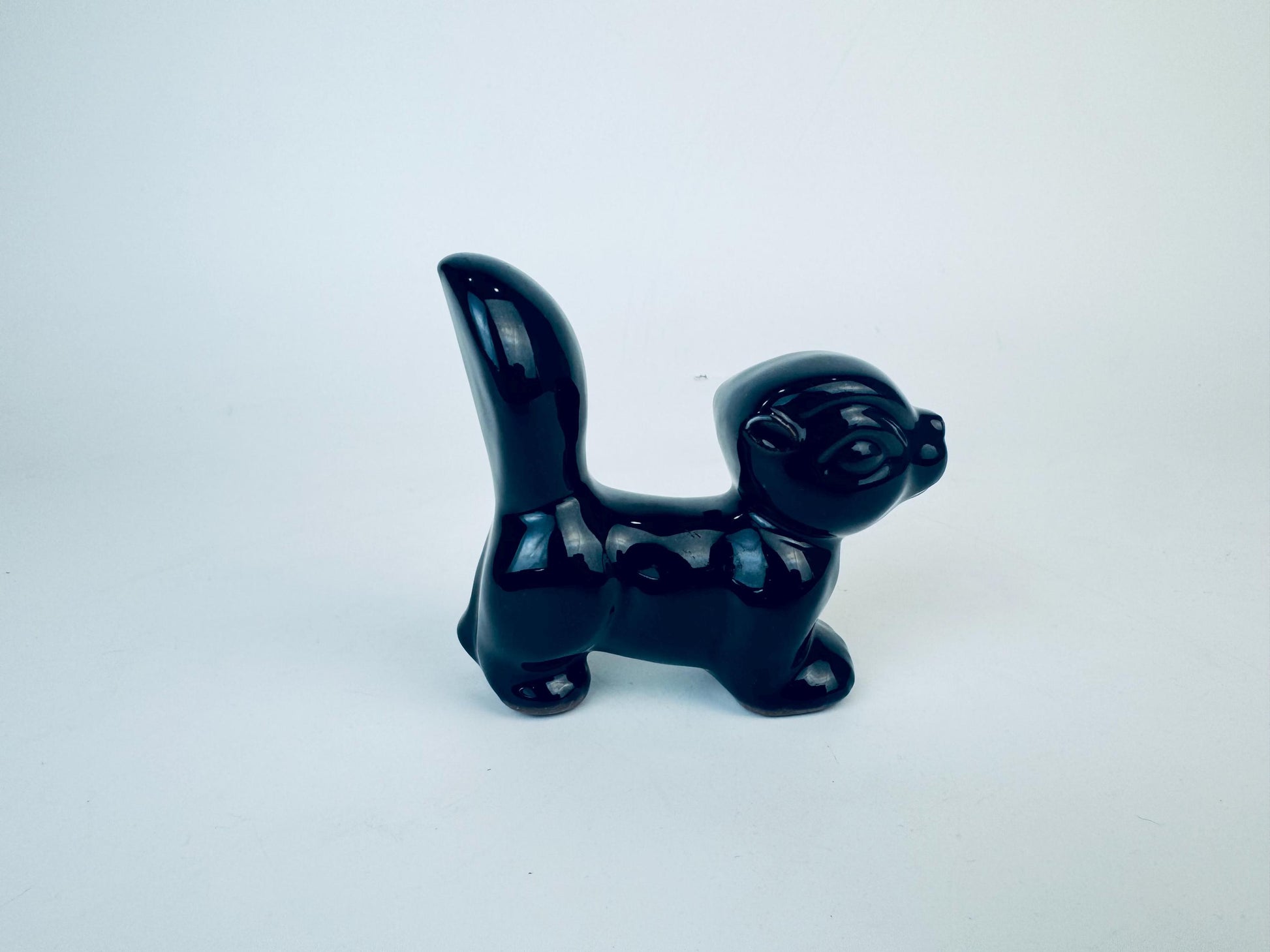 Product image for 'vintage kitsch black skunk red clay figurine made in japan' (view c36768)