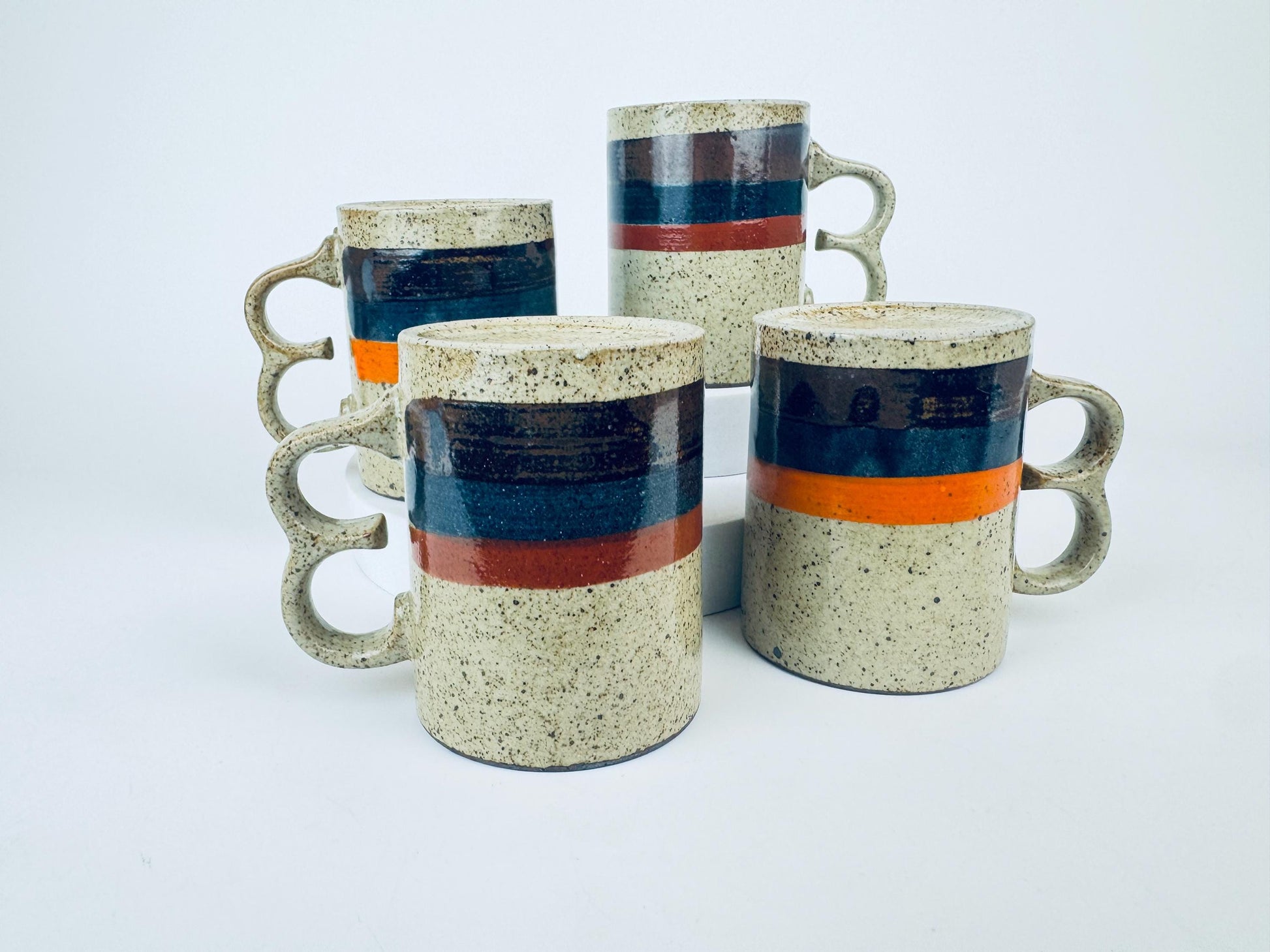 Product image for 'vintage 1970s stoneware mugs speckled glaze with bold stripes double loop handles set of 4 retro coffee cups' (view b44975)