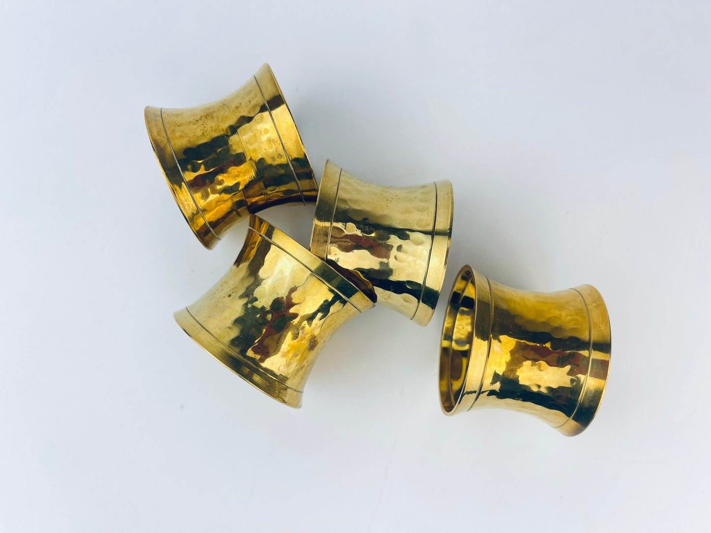 Product image for 'vintage hammered brass hourglass shaped napkin ring holders set of four 4 attractive aged metal patina' (view 2ecbe9)