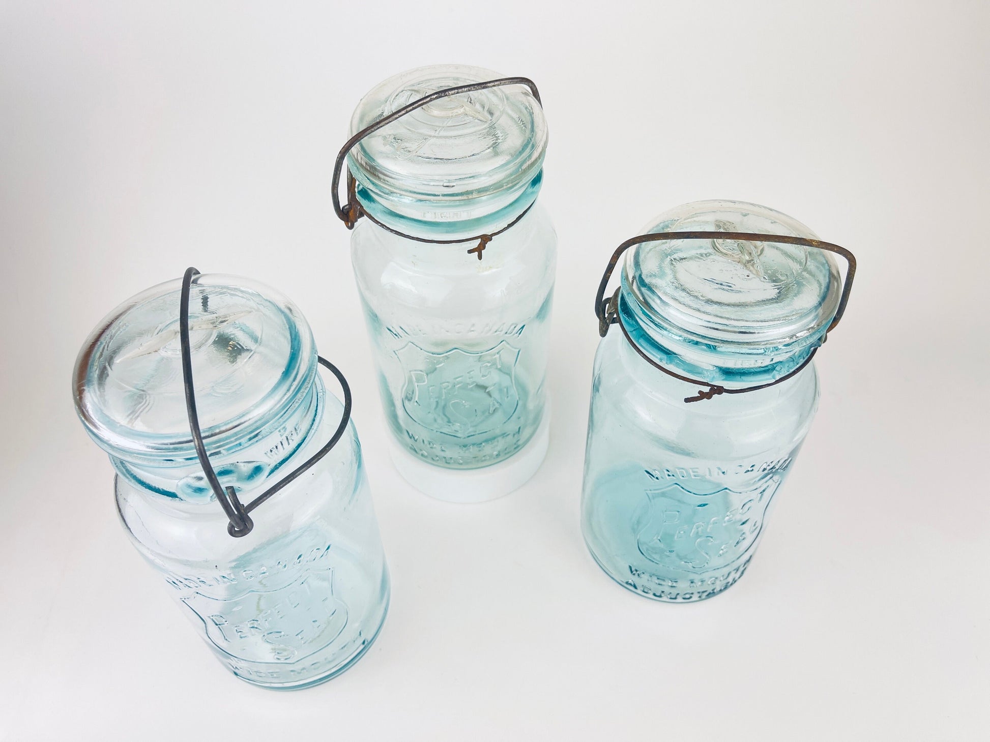 Product image for 'antique safety seal wide mouth aqua blue glass jar 2 pint capacity lightning metal hinge clasp made in canada sold separately 1' (view ea3a47)