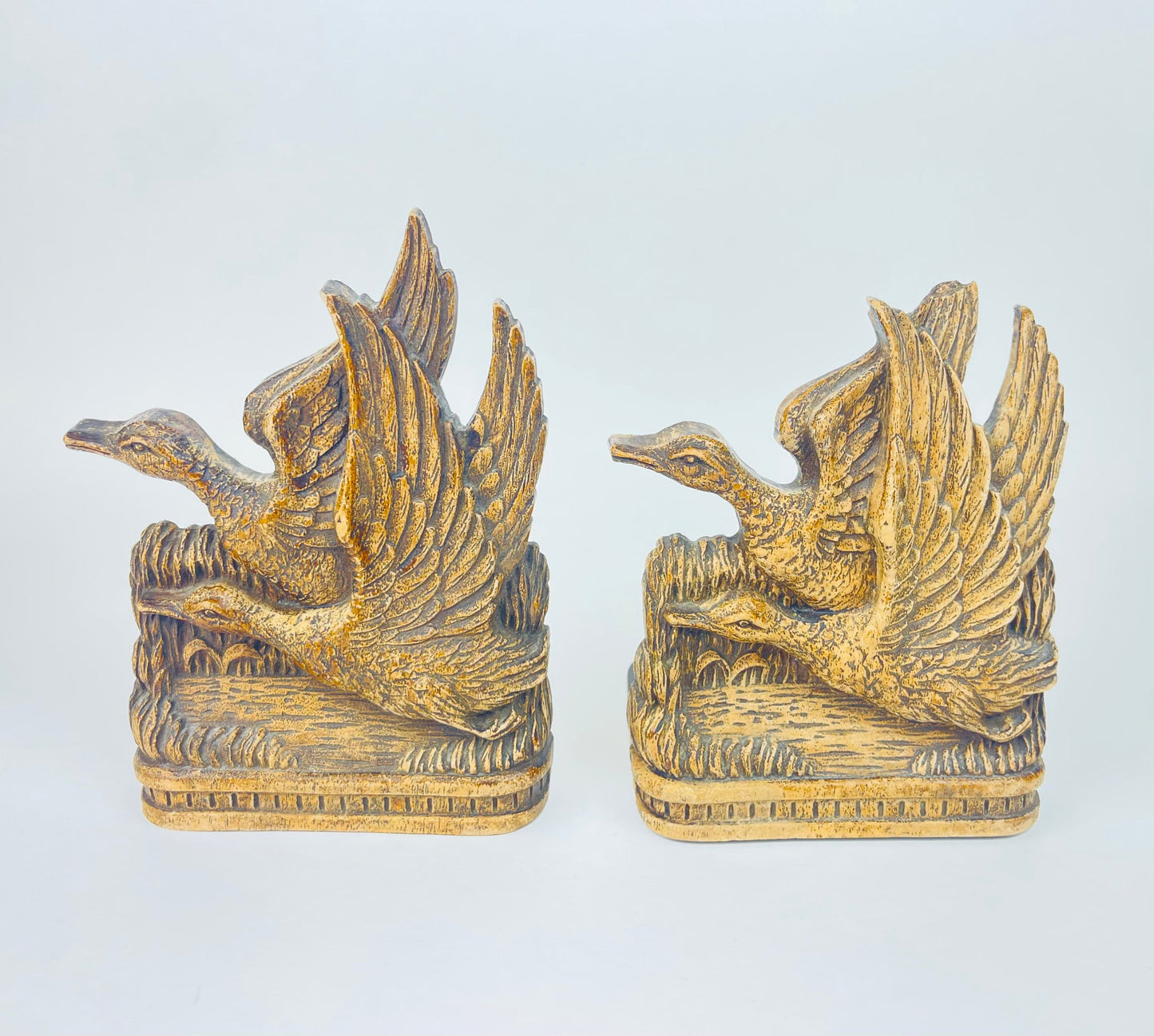 Front view of carved wooden Durwood duck bookends with wings raised