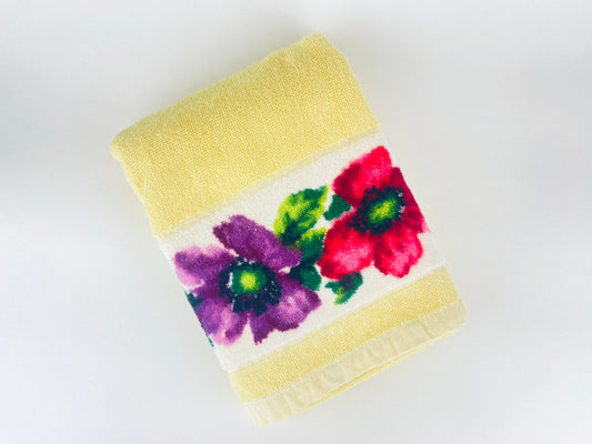 Bath towel with floral design on a white background