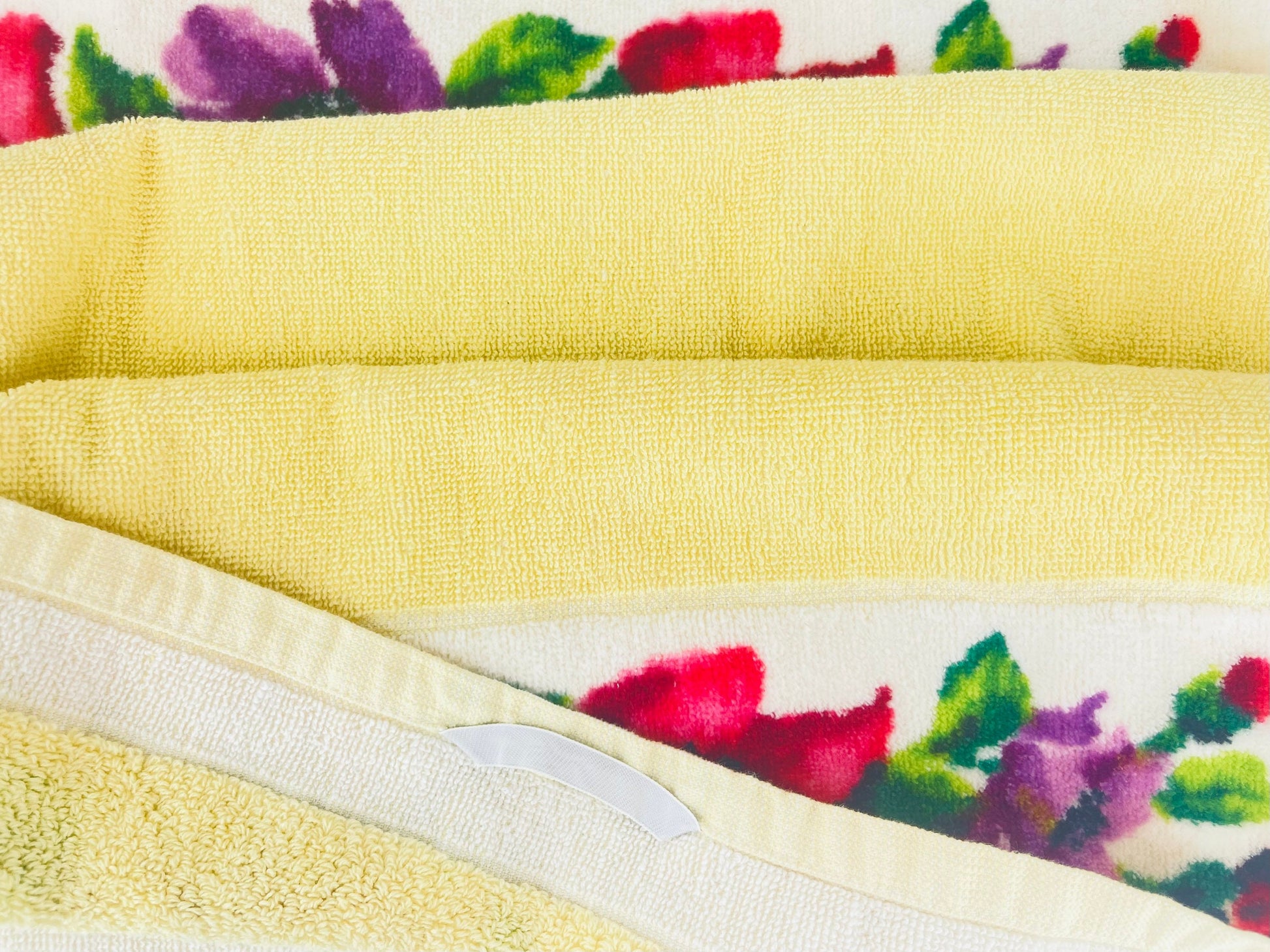 Yellow towel with floral patterned border