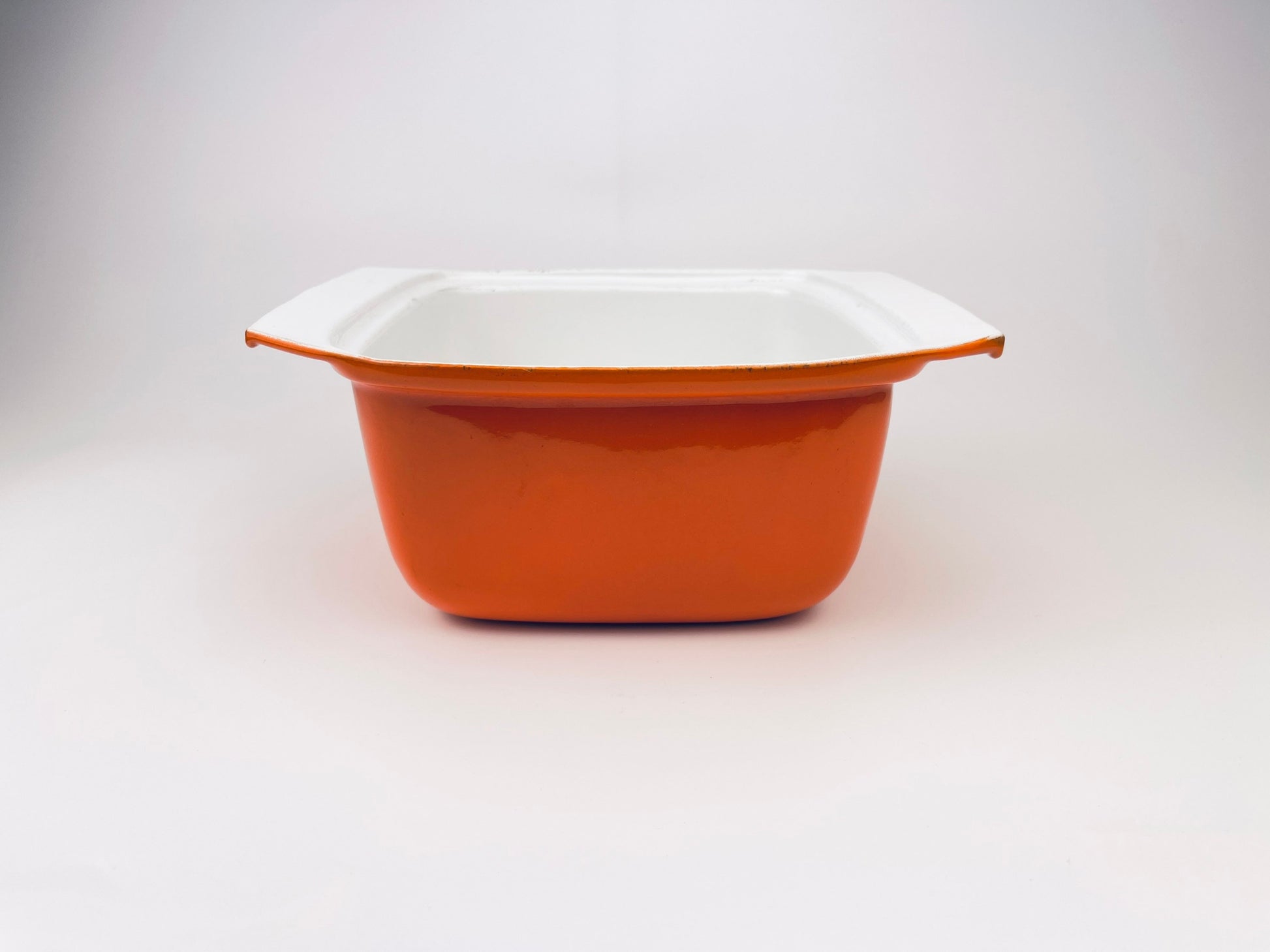 Orange and white dish on a light gray background