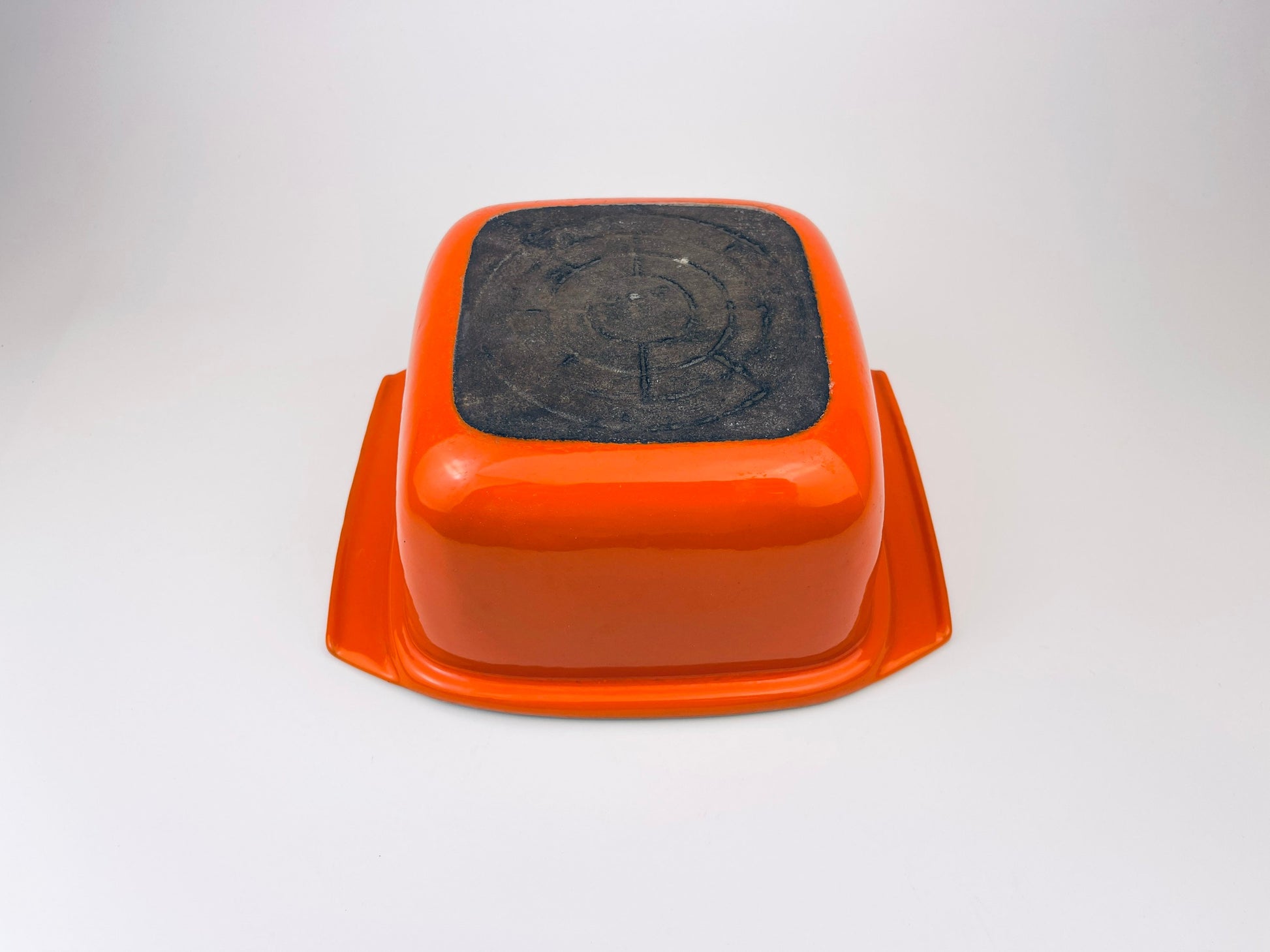 White ceramic coated cast iron square bowl on a light gray background