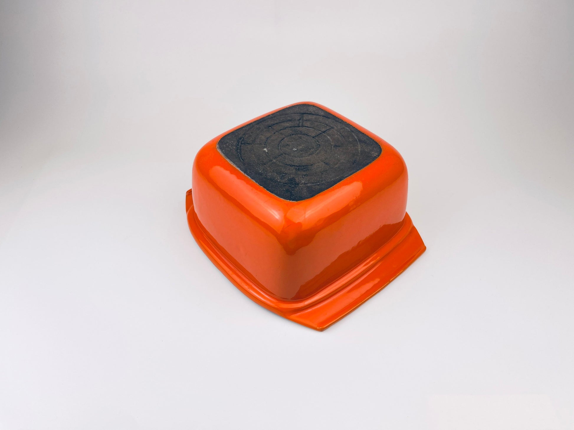 White ceramic coated cast iron square bowl on a light gray background