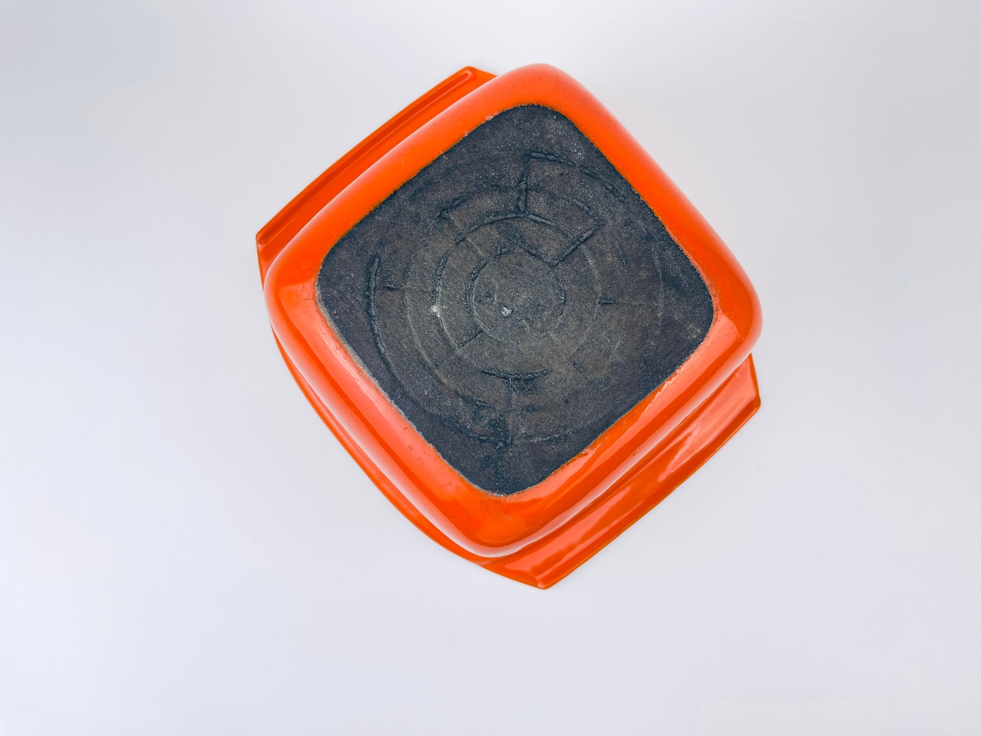 White ceramic coated cast iron square bowl on a light gray background