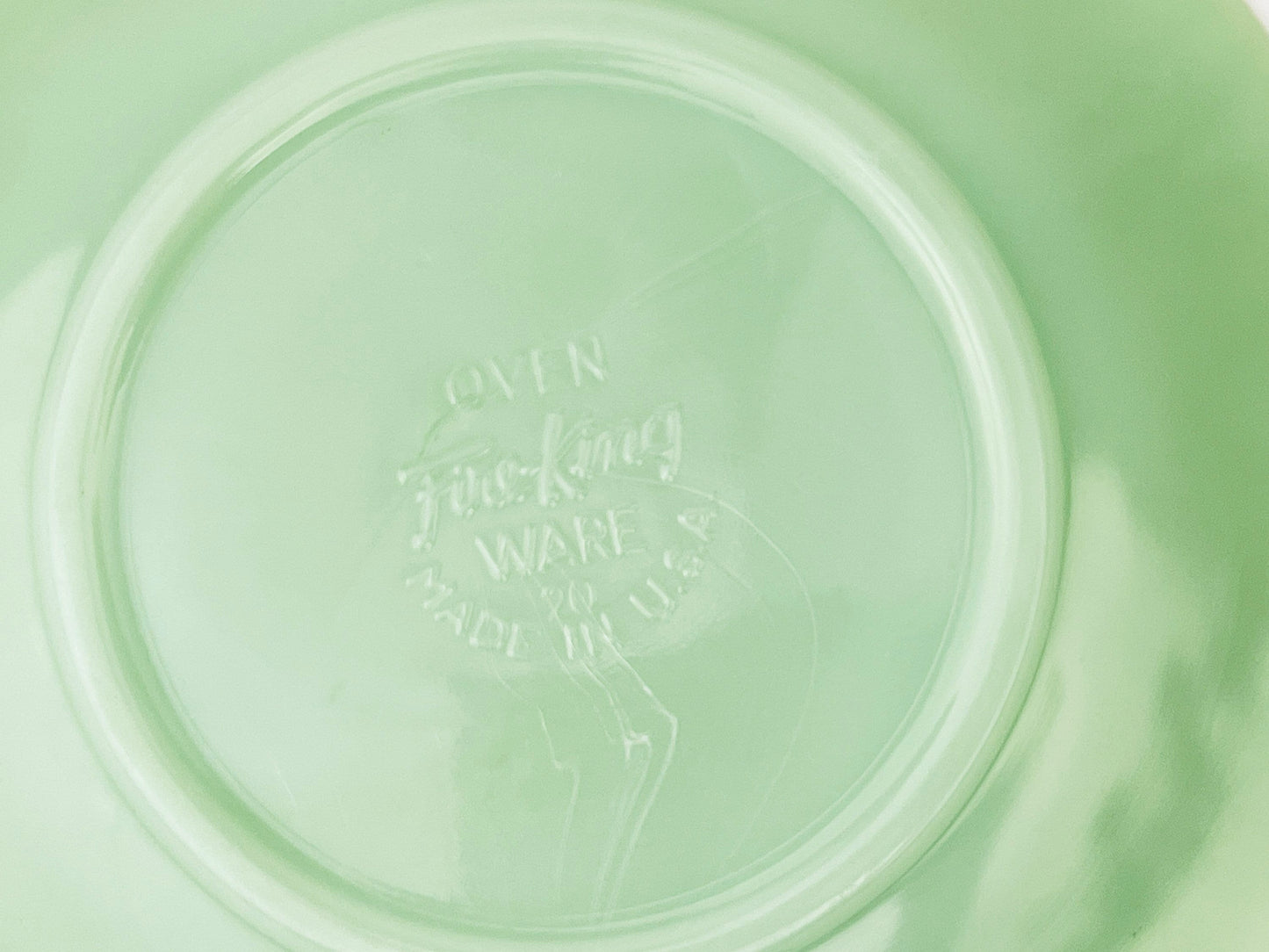 Green jadeite saucer on a white background