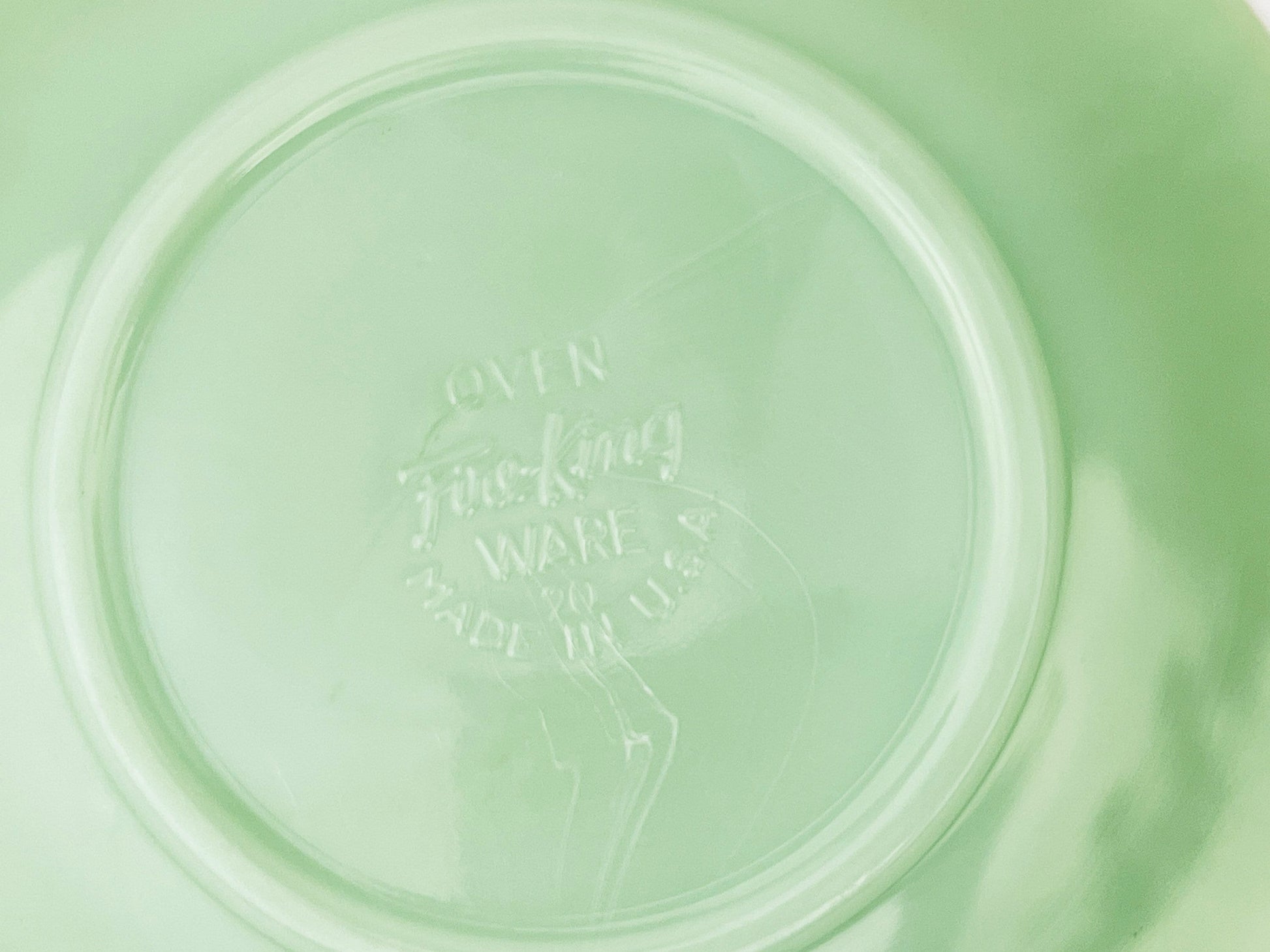 Green jadeite saucer on a white background