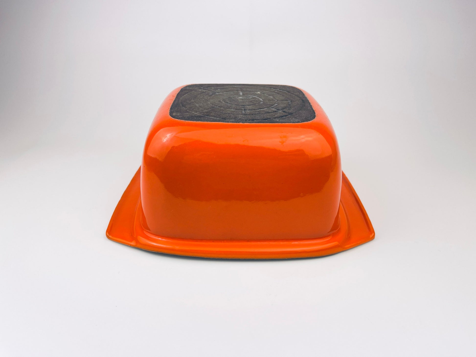 White ceramic coated cast iron square bowl on a light gray background