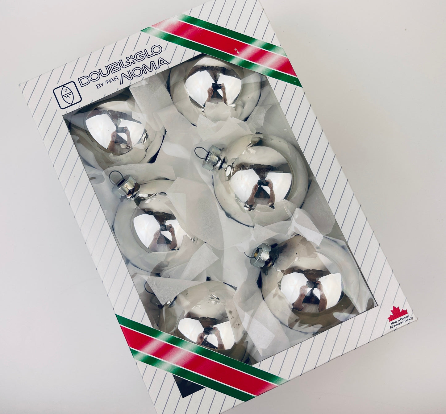 Packaged silver Christmas ornaments with 'Doubleglo' branding on a white background