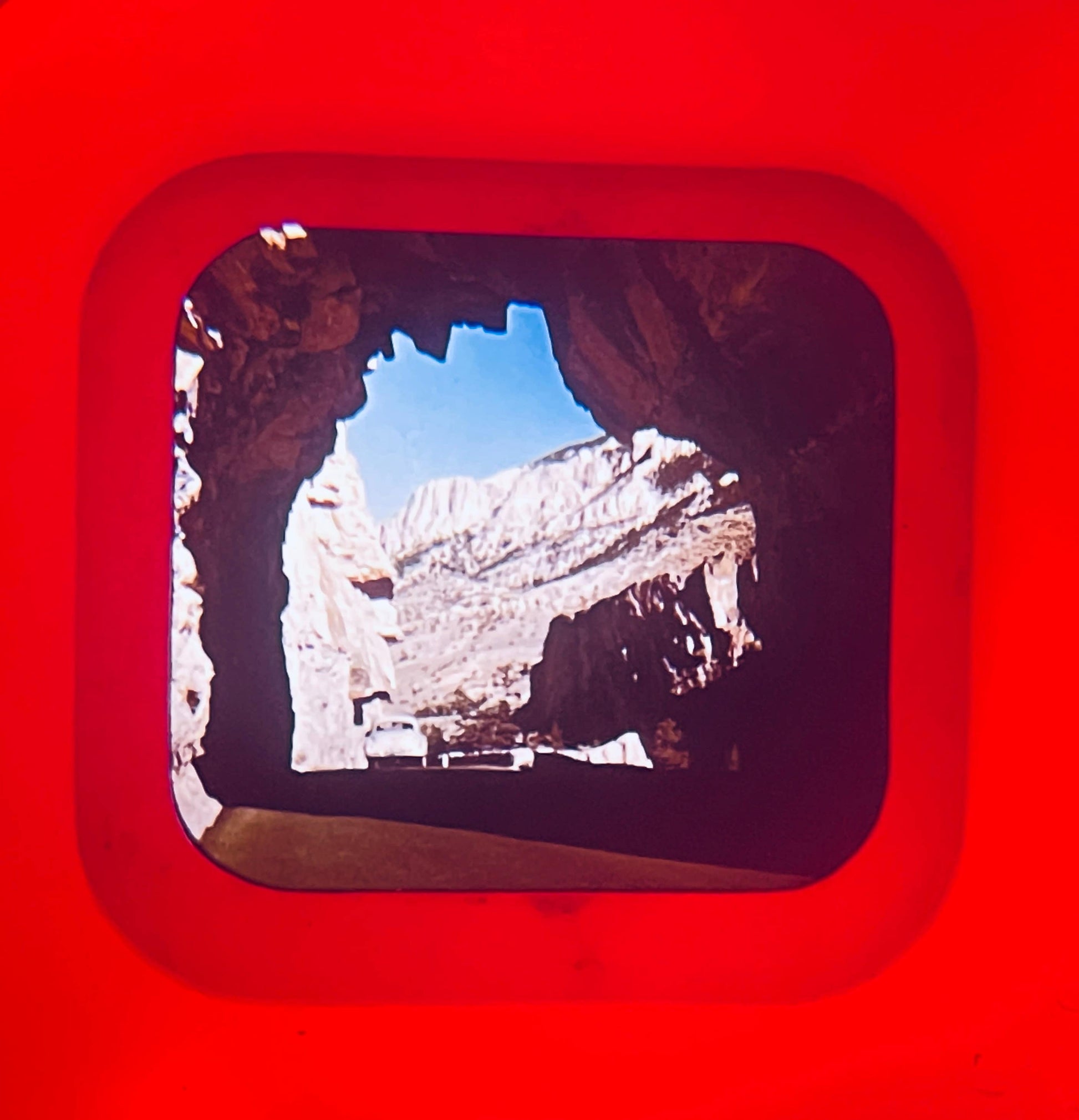 Rock formation viewed through a square window with a red border