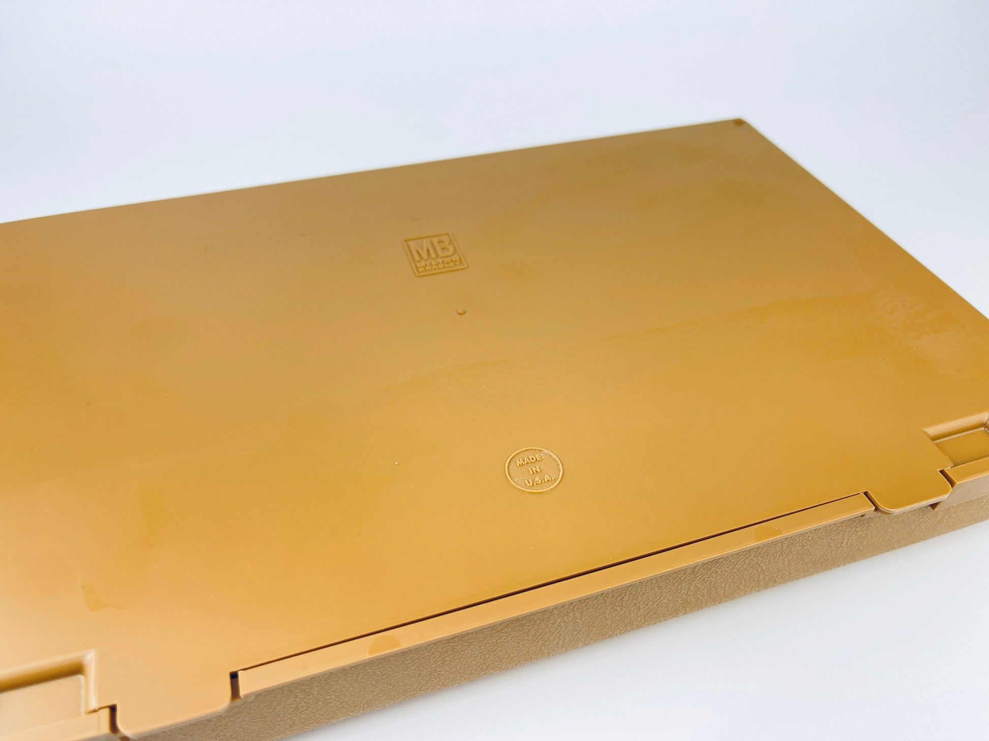 Gold-colored box with a brand logo on a white background