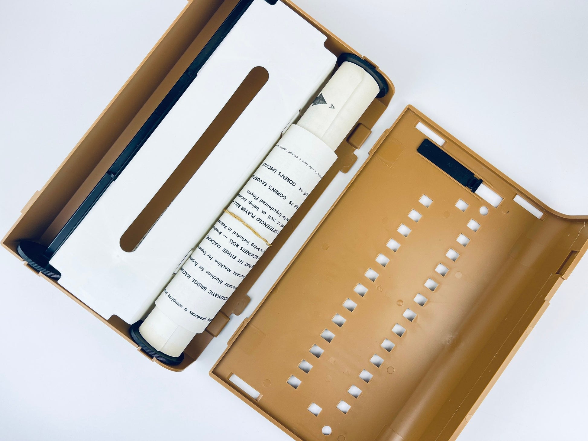 Brown box with a white cylindrical object inside on a white background