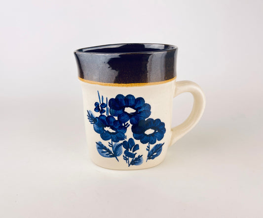 Vintage off-white ceramic jug with hand-painted cobalt blue floral decoration and a sturdy handle, mid-century German Keramo Kostelec pitcher on white background.