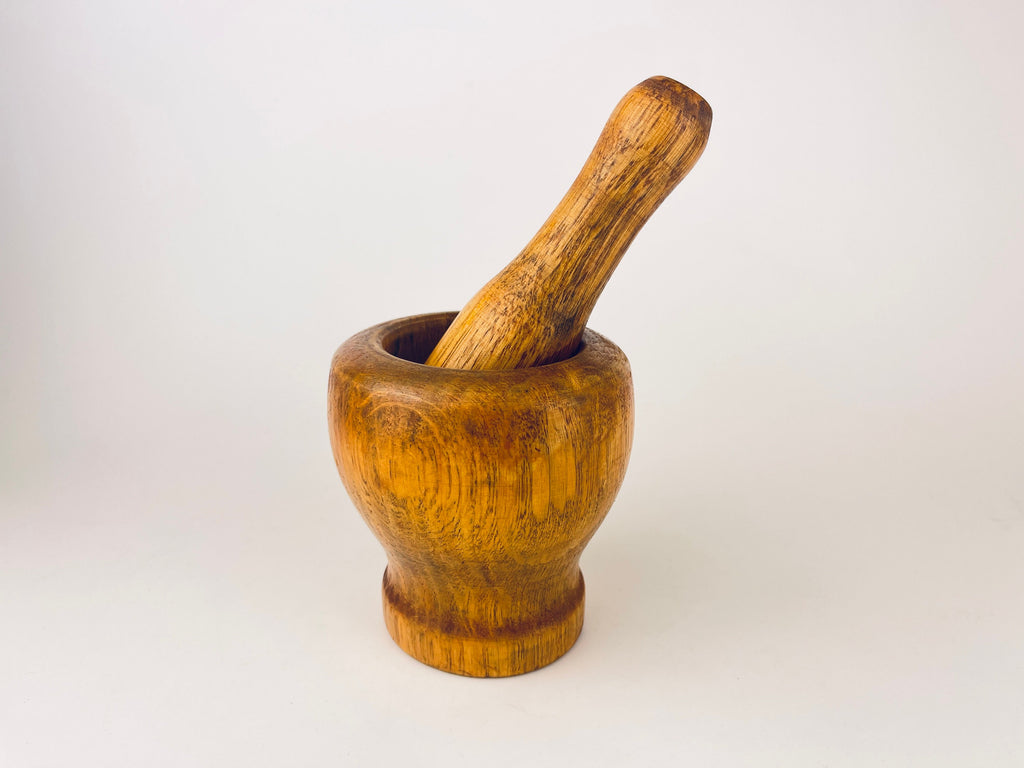 Wooden mortar and pestle on a white background