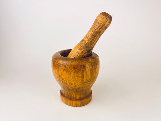 Wooden mortar and pestle on a white background