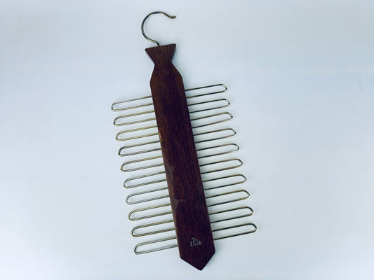 Vintage walnut wood tie-shaped rack with gold metal loops, shown on a white background. West Germany “Tie Rack” organizer for ties or belts.