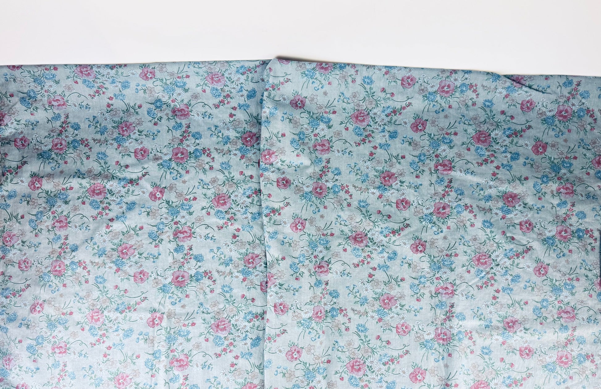Floral fabric with pink and blue flowers on a white background