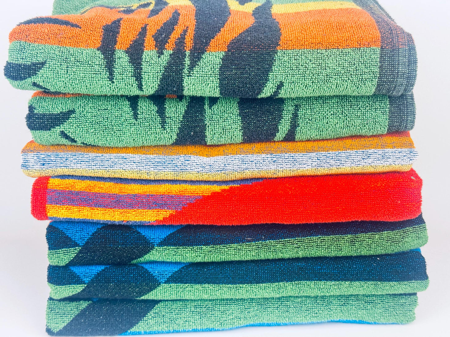 Stack of colorful beach towels on a white background