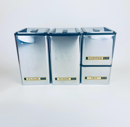 Set of four storage containers labeled 'Flour', 'Sugar', 'coffee' and 'Tea' on a white background.