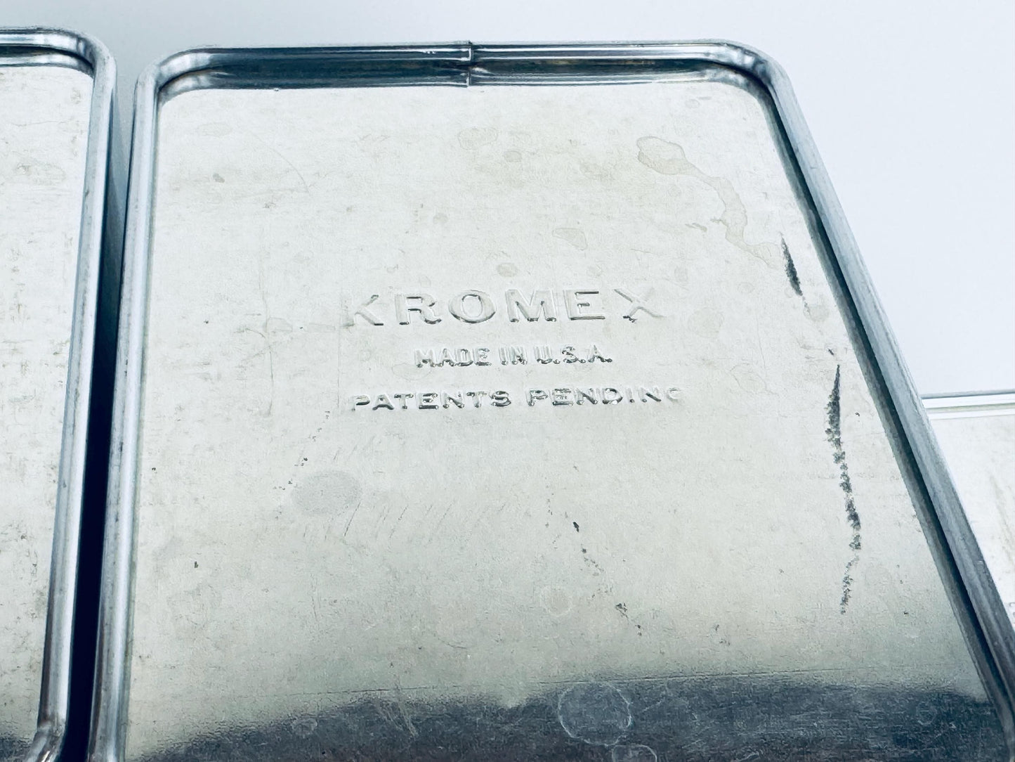 Close-up of a Kromex product with 'Made in U.S.A.' and 'Patents Pending' text
