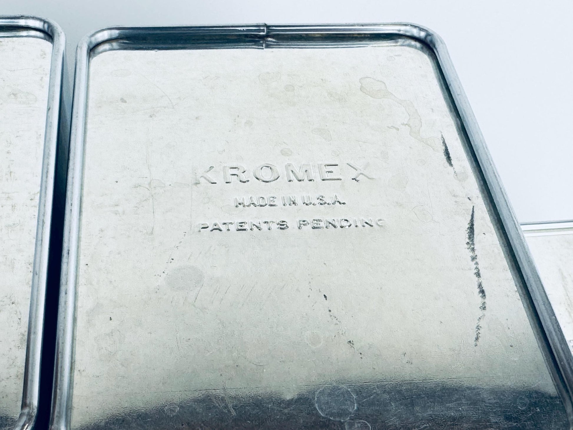 Close-up of a Kromex product with 'Made in U.S.A.' and 'Patents Pending' text