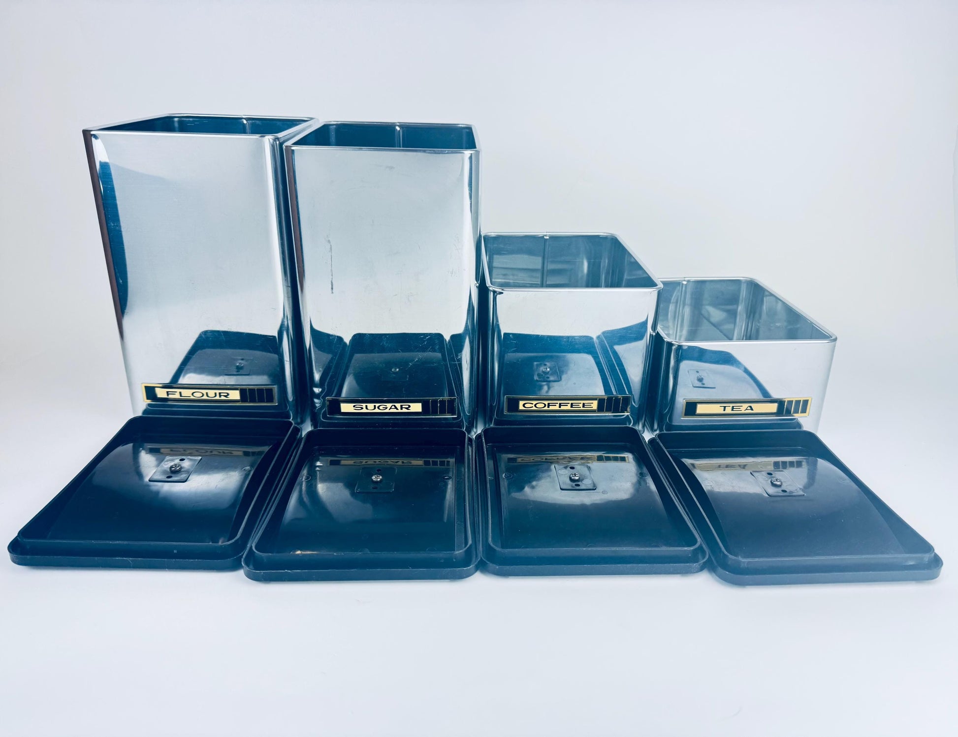 Set of silver metal containers on a white background