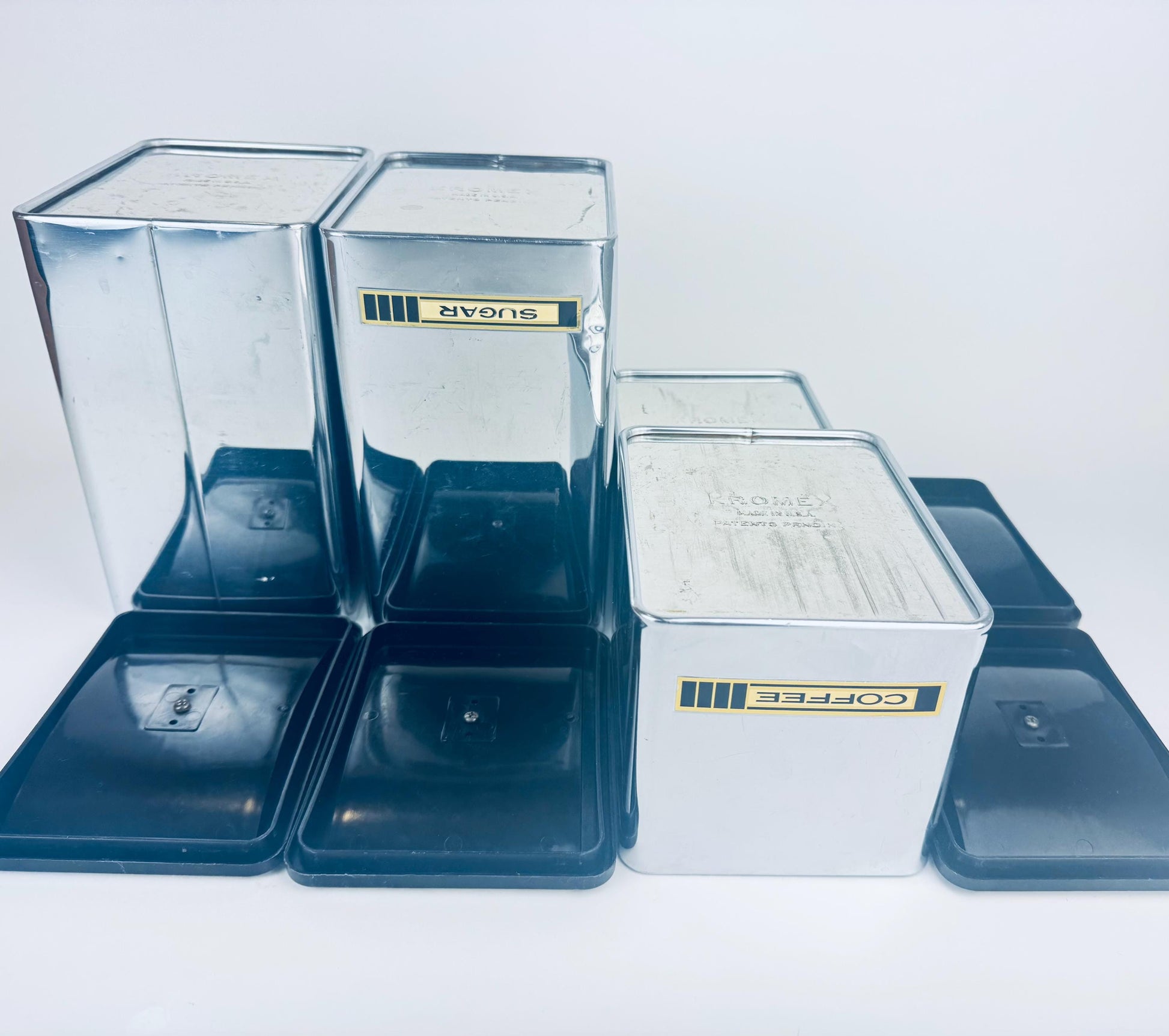 Set of silver storage bins with lids on a white background
