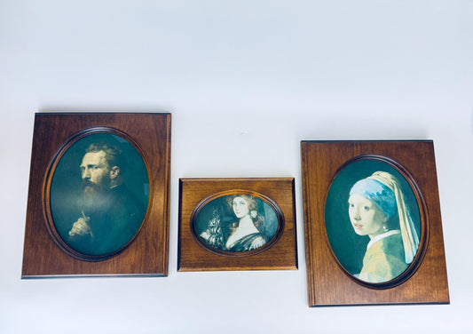 Trio of vintage carved oval wood frames with rich brown walnut finish, shown side by side with portraits inside