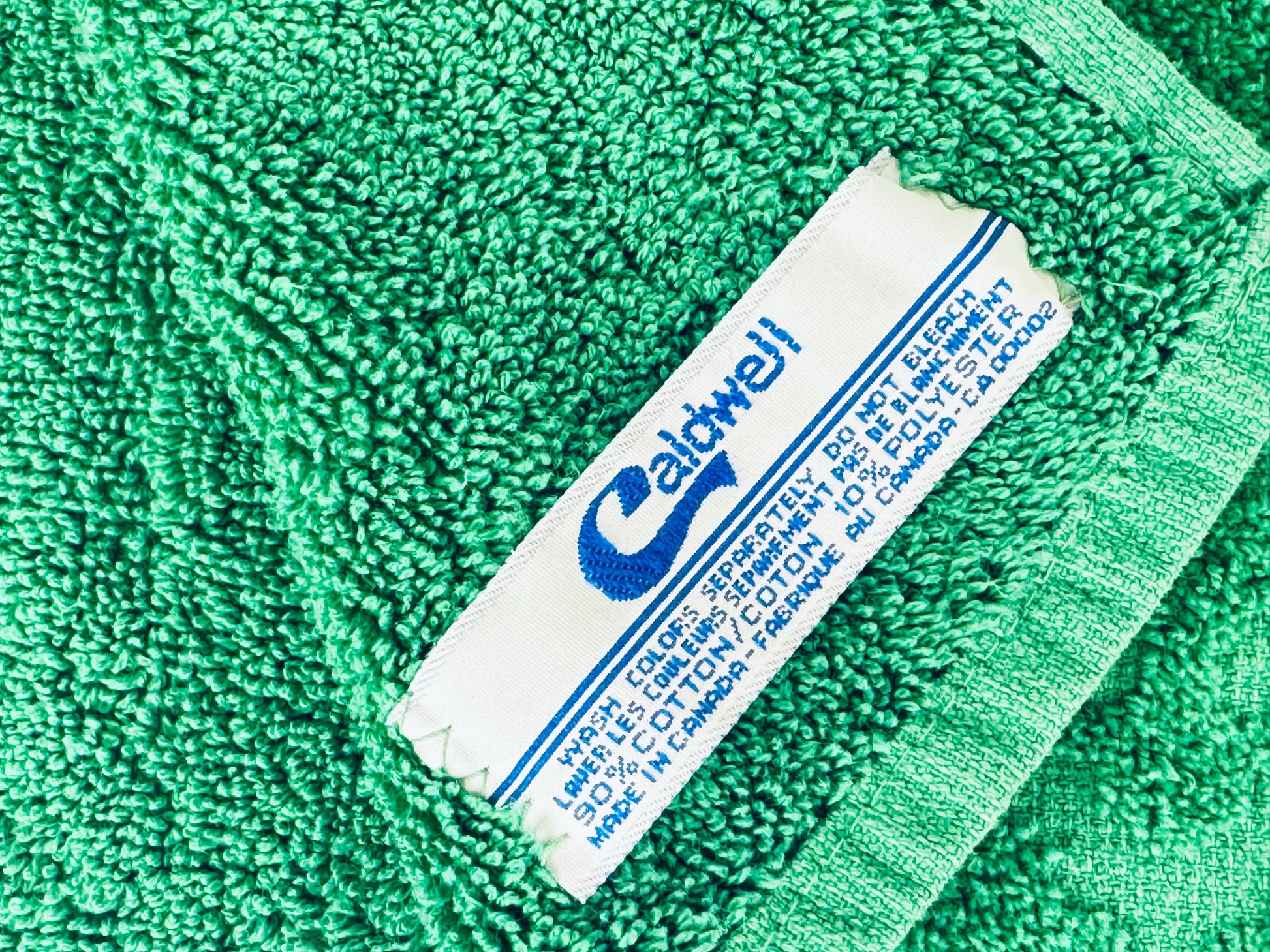 Green towel with a label on a green background