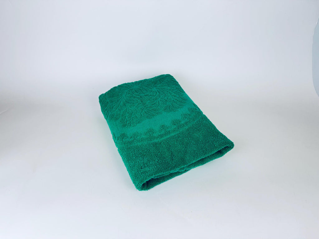 Green towel with a pattern on a white background