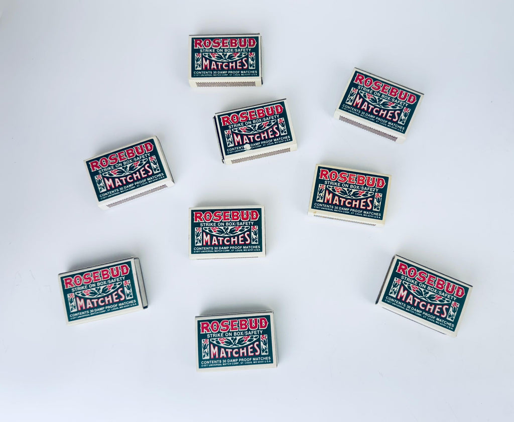 Multiple boxes of Rosebud matches arranged on a white background