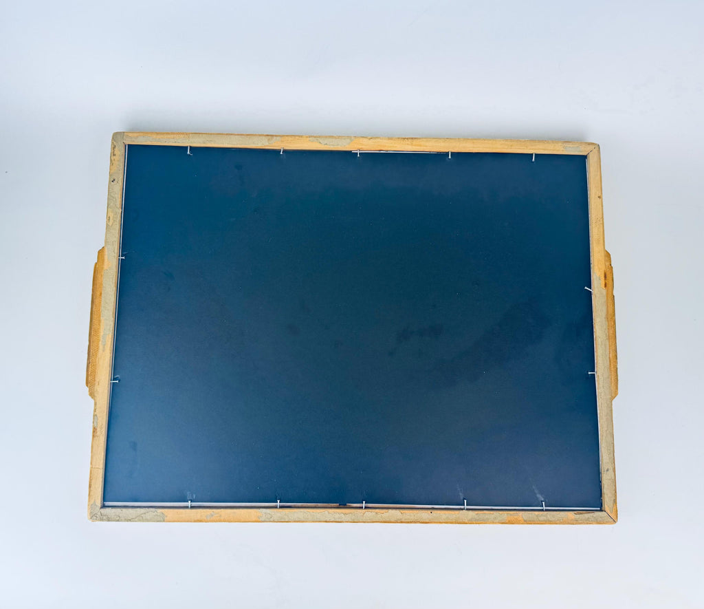 Back of framed botanical illustration of flowers in carved wooden handled tray. 