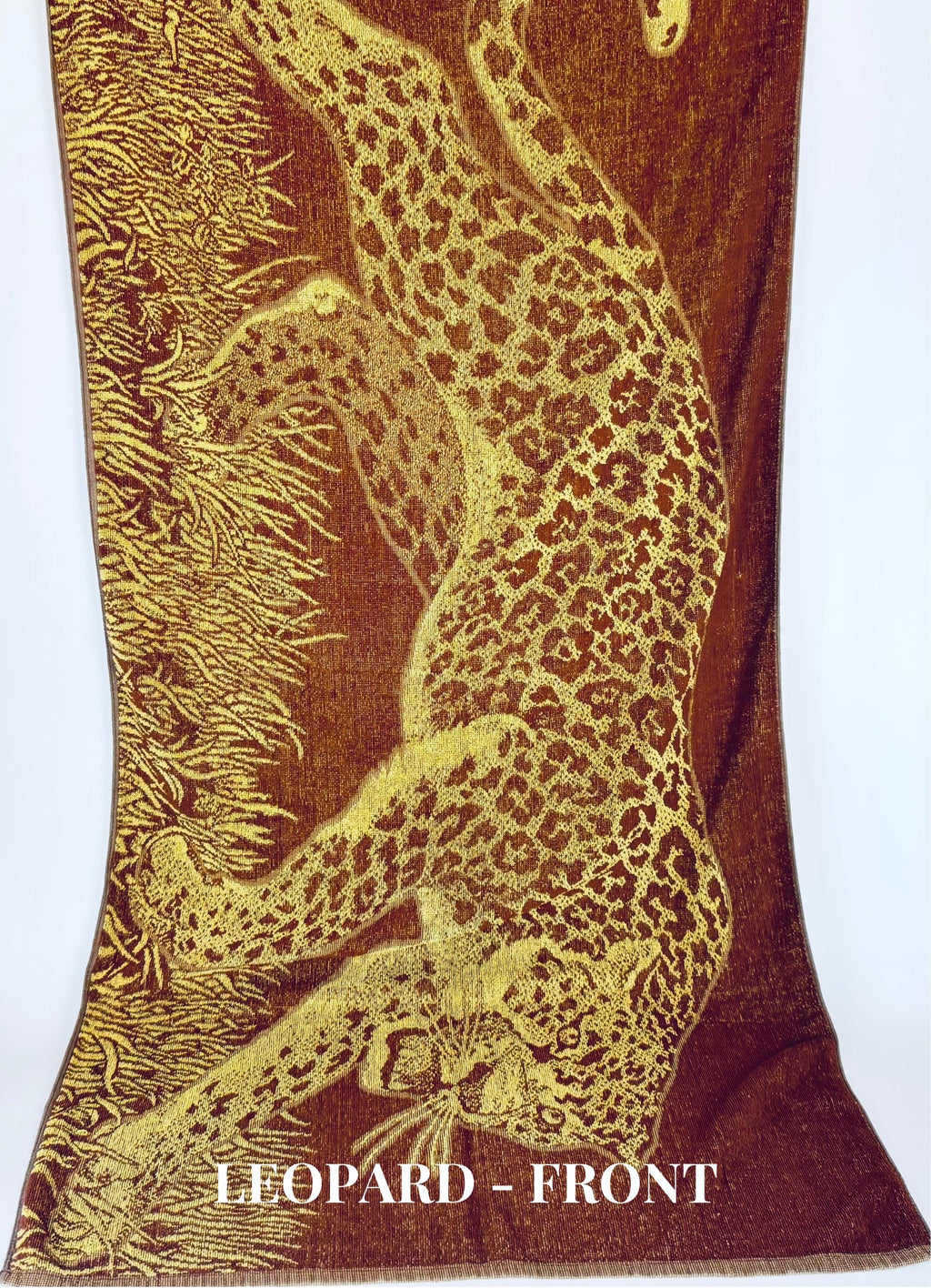 Textile with a leopard design on a brown background