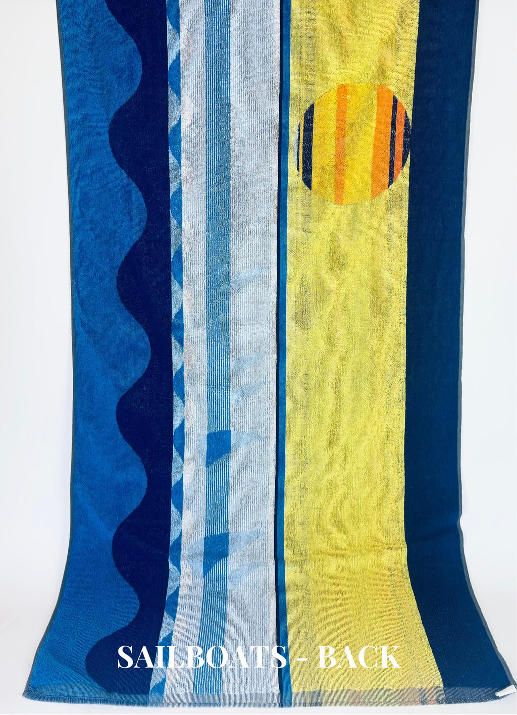 Colorful towel with abstract patterns and 'SAILBOATS - BACK' text on a white background